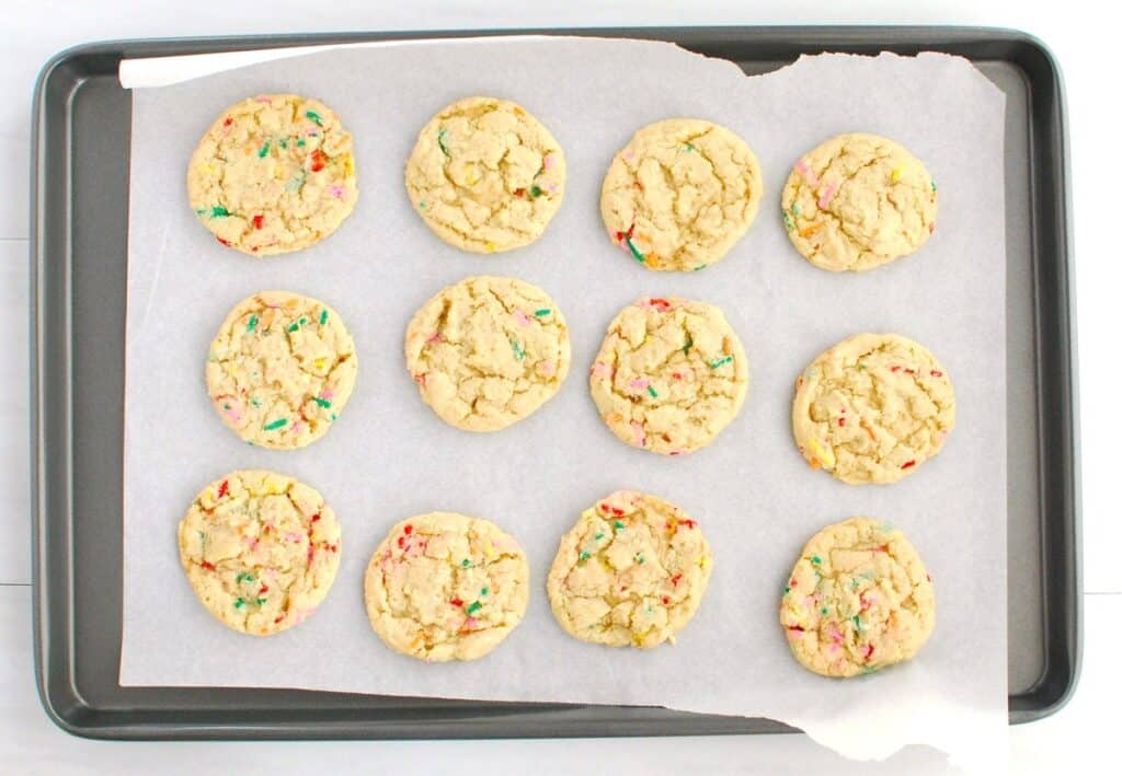 A tray of baked birthday cake cookies.
