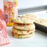 A stack of four dairy-free birthday cake cookies.