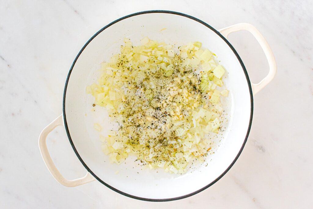 Onions sauteed in a skillet with seasonings.
