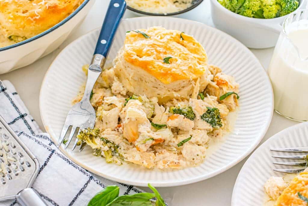 A plate with a serving of dairy free broccoli chicken biscuit bake, with a fork next to it.