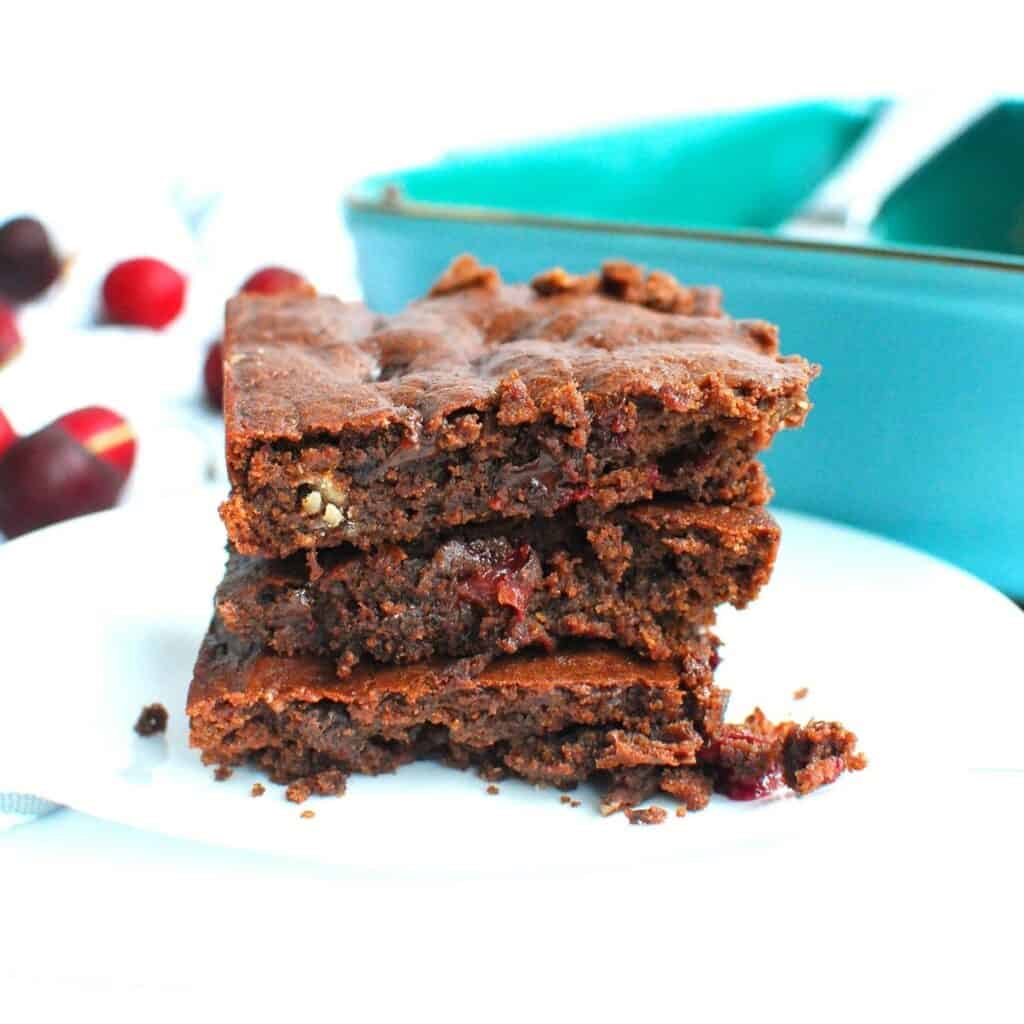 A stack of three dairy free cherry black bean brownies.