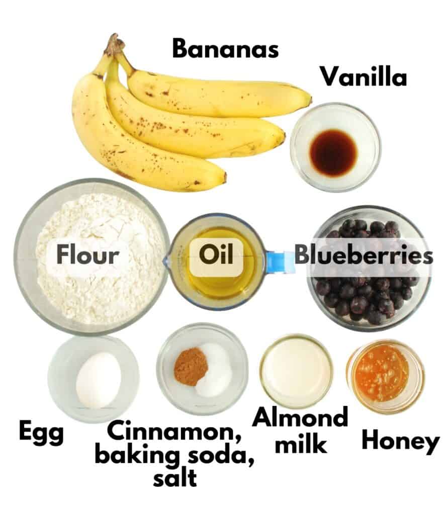 Bananas, vanilla, flour, oil, blueberries, egg, cinnamon, baking soda, salt, almond milk, and honey.