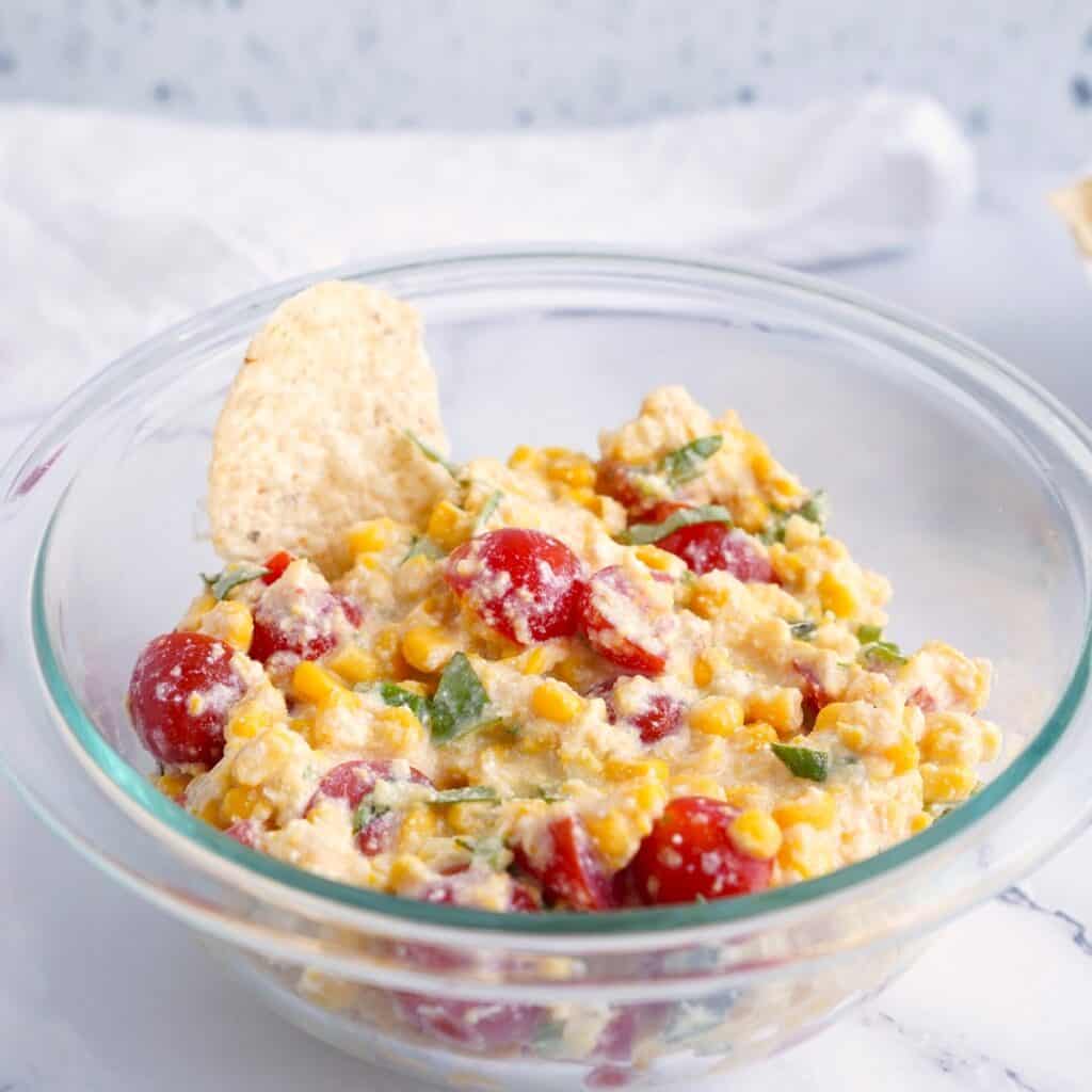 A bowl of dairy free corn and tomato dip.
