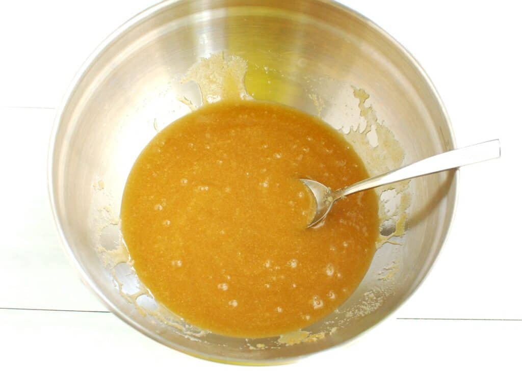 All the wet ingredients whisked together in a silver mixing bowl.
