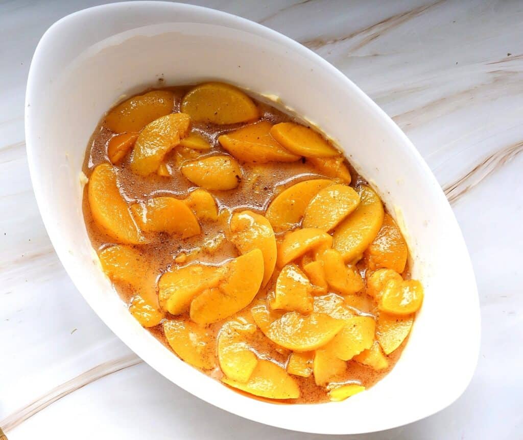 The peach filling mixture in a baking dish.