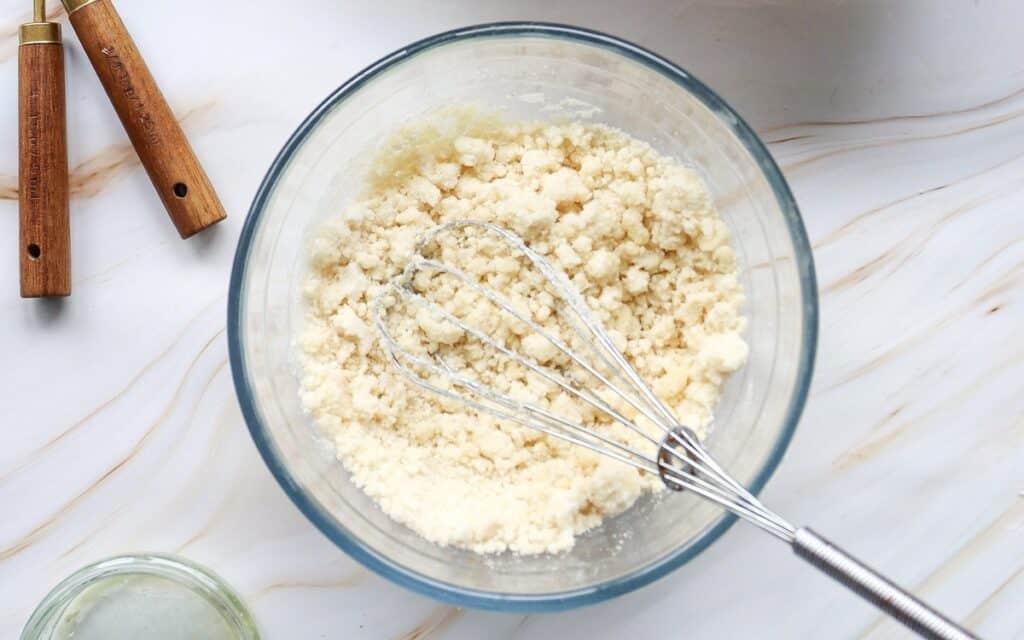 Butter cut into the flour mixture in a mixing bowl.