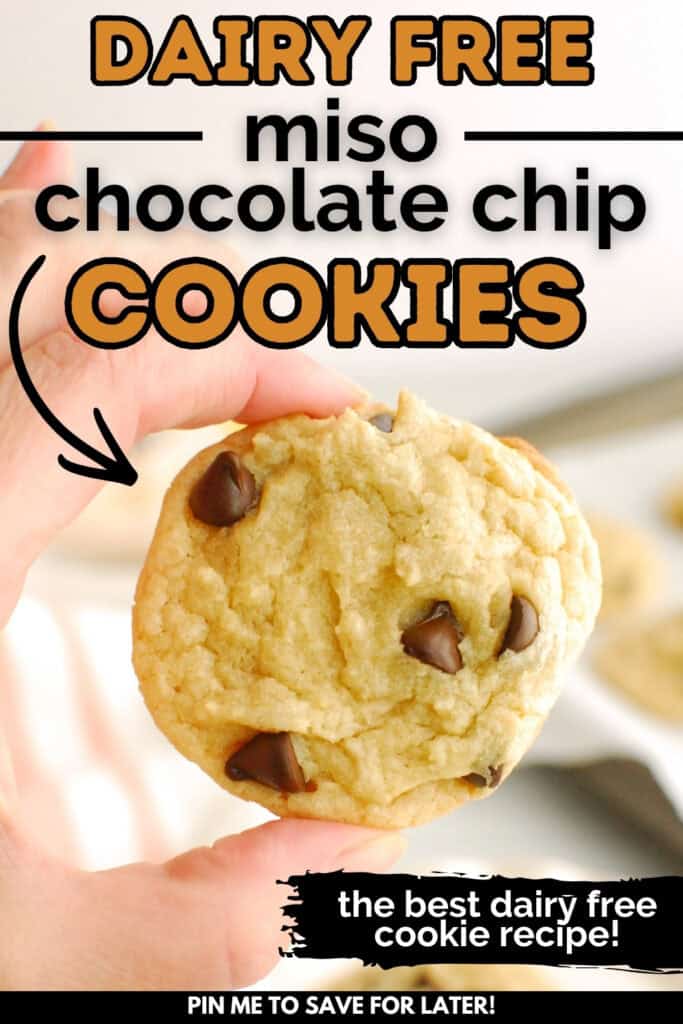 A woman's hand holding a dairy free miso chocolate chip cookie with a text overlay with the name of the recipe.