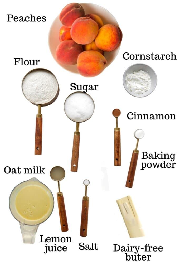 Peaches, cornstarch, sugar, flour, cinnamon, baking powder, lemon juice, oat milk, salt, and dairy-free butter.