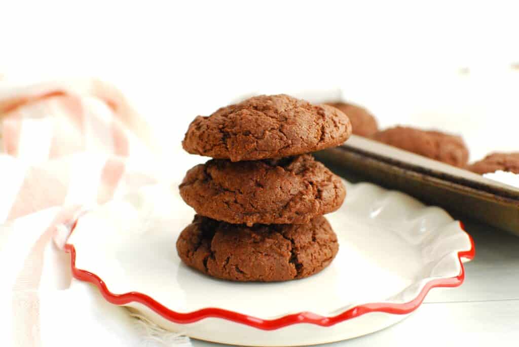 Three cake mix cookies on a small white plate.