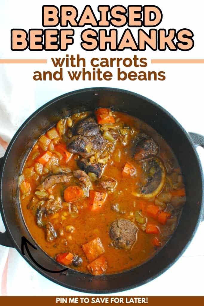 A dutch oven filled with braised beef shanks with carrots and white beans with a text overlay with the name of the recipe.