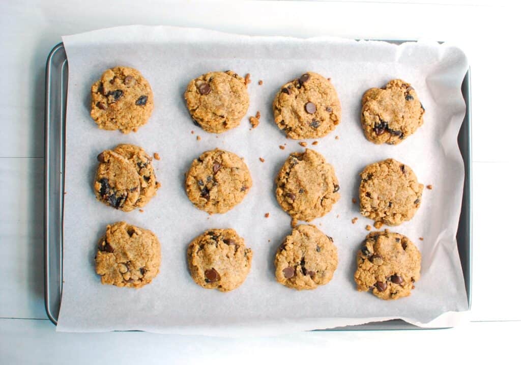 Baked cookies on a parchment-lined baking sheet.