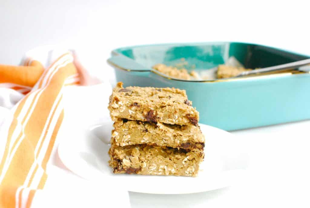 A stack of three allergen friendly oatmeal bars on a plate.