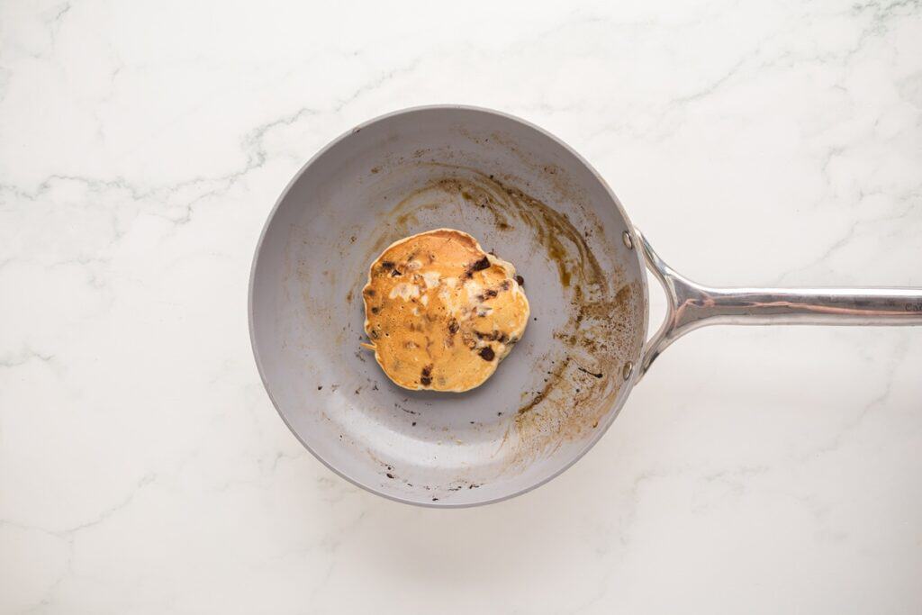 A pancake in a skillet.