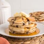 Four dairy free chocolate chip pancakes stacked on top of each other.