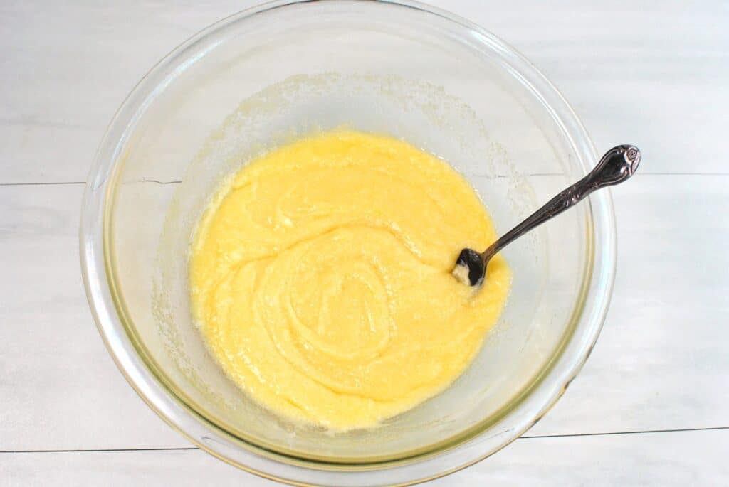Dairy-free butter, sugar, egg, and vanilla mixed together in a glass bowl.
