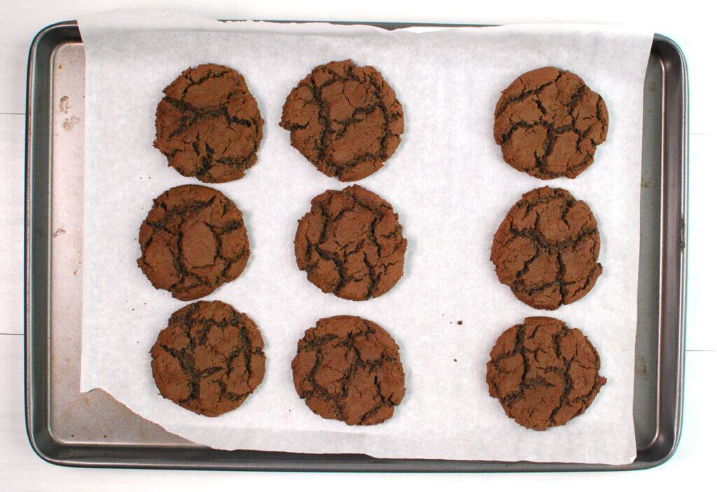 Just-baked dairy-free chocolate cookies on a baking sheet.