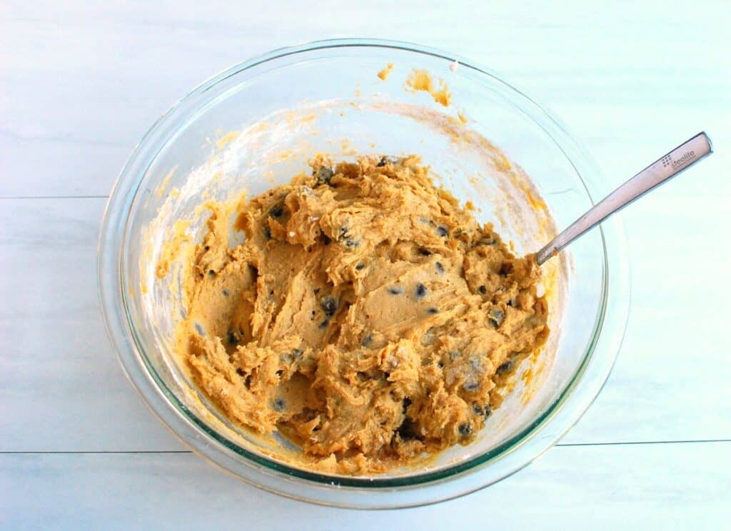 The cookie dough batter with chocolate chips in a mixing bowl.