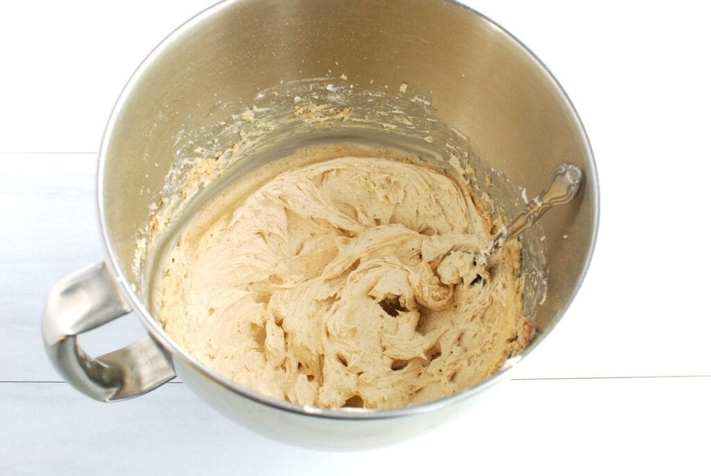 Cinnamon buttercream frosting in a mixing bowl.