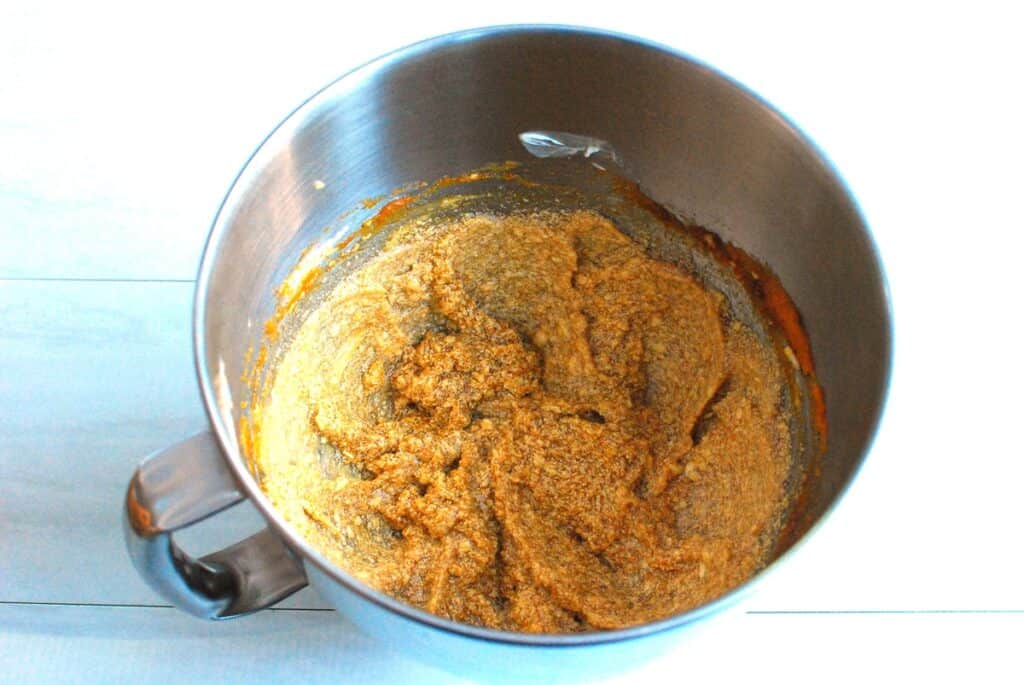 Pumpkin, dairy-free butter, sugar, brown sugar, and vanilla mixed together in a bowl.