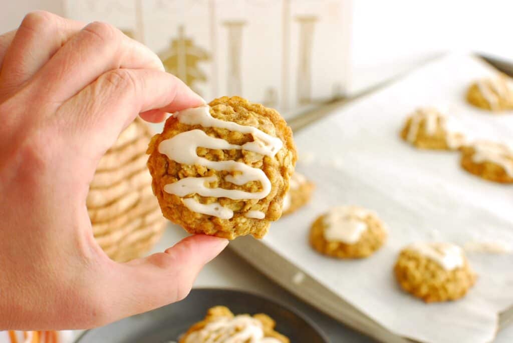 A hand holding a dairy free pumpkin oatmeal cookie.