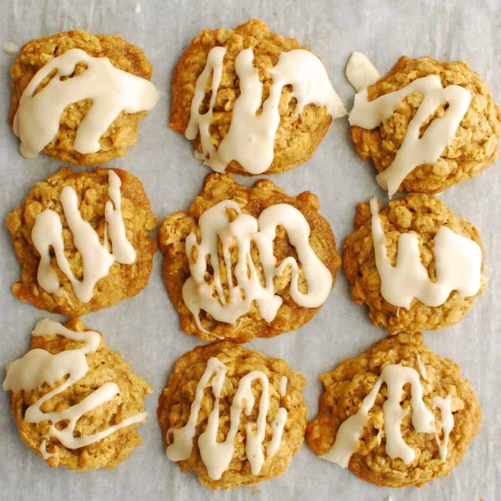 A bunch of dairy free egg free pumpkin oatmeal cookies on parchment paper.