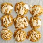 A bunch of dairy free egg free pumpkin oatmeal cookies on parchment paper.