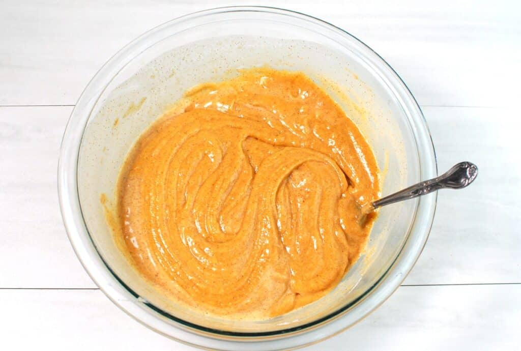 Cupcake batter in a glass mixing bowl.